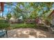 Backyard featuring manicured landscaping, brick patio, and mature trees providing ample shade at 13563 Cordova Dr, Largo, FL 33774