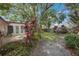 Exterior view of home featuring well-maintained landscaping and patio at 13563 Cordova Dr, Largo, FL 33774