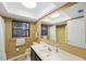 Comfortable bathroom with ample mirror, single vanity, toilet and walk-in shower at 13563 Cordova Dr, Largo, FL 33774