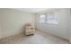 Neutral bedroom with a relaxing chair and window letting in light at 13563 Cordova Dr, Largo, FL 33774