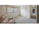 Neutral bedroom with ample light, closet space and a relaxing chair at 13563 Cordova Dr, Largo, FL 33774