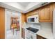 Kitchen with sleek countertops, classic cabinetry, and view of the dining area at 13563 Cordova Dr, Largo, FL 33774
