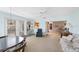 Relaxing living area with a ceiling fan, with views to the kitchen and additional seating area at 13563 Cordova Dr, Largo, FL 33774