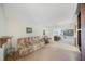 Open-concept living room featuring neutral colors, ceiling fan, and lots of natural light at 13563 Cordova Dr, Largo, FL 33774