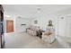 Bright living room with neutral carpet, ceiling fan, and comfortable seating at 13563 Cordova Dr, Largo, FL 33774