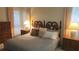 Comfortable main bedroom with a wood-carved headboard, bedside tables, and natural light at 13563 Cordova Dr, Largo, FL 33774