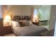 Comfortable main bedroom with a wood-carved headboard, bedside tables, and ensuite bathroom at 13563 Cordova Dr, Largo, FL 33774