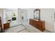Main bedroom featuring a dresser with a mirror and closet with an ensuite bathroom at 13563 Cordova Dr, Largo, FL 33774
