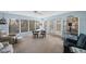 Cozy sun room with lots of windows for natural light, a ceiling fan, and comfortable seating area at 13563 Cordova Dr, Largo, FL 33774