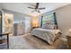 Bedroom with a cozy quilt, soft lighting and a doorway leading to the bathroom at 14000 104Th Ave, Largo, FL 33774