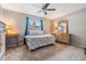 Cozy bedroom featuring a ceiling fan, carpet, and a charming quilt-covered bed at 14000 104Th Ave, Largo, FL 33774