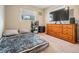 Bedroom with a bed, large dresser, and a television at 14000 104Th Ave, Largo, FL 33774
