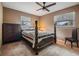 Cozy bedroom with a four-poster bed, ceiling fan and carpet flooring at 14000 104Th Ave, Largo, FL 33774