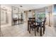 Inviting dining room featuring a large mirror, tiled floors, and a window with natural light at 14000 104Th Ave, Largo, FL 33774