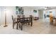 Bright dining room featuring tiled flooring, an elegant light fixture, and tasteful decorations at 14000 104Th Ave, Largo, FL 33774