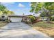 Beautiful home with a long driveway, an attached two-car garage, and well maintained landscaping at 14000 104Th Ave, Largo, FL 33774