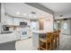 Bright kitchen featuring white cabinets, tile countertops, and bar seating at 14000 104Th Ave, Largo, FL 33774