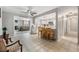 Open-concept kitchen flowing into the living area with white cabinetry and breakfast bar seating at 14000 104Th Ave, Largo, FL 33774