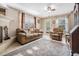 Bright living room with fireplace, cozy seating, and natural light at 14000 104Th Ave, Largo, FL 33774
