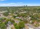 Aerial view of a home in a lush neighborhood with a city skyline in the distance at 1436 30Th N Ave, St Petersburg, FL 33704