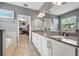 Elegant bathroom with dual sinks, granite counters, and a separate tub and closet at 1436 30Th N Ave, St Petersburg, FL 33704