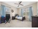 Bedroom with blue curtains, ceiling fan, desk, and single bed at 1436 30Th N Ave, St Petersburg, FL 33704