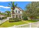 Charming two-story home with a manicured lawn, white picket fence, and inviting front entrance at 1436 30Th N Ave, St Petersburg, FL 33704