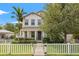 Charming two-story home featuring a white picket fence, manicured landscaping, and a welcoming front entrance at 1436 30Th N Ave, St Petersburg, FL 33704