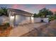 Detached two-car garage with a paved driveway, exterior lighting, and a privacy fence in the backyard at 1436 30Th N Ave, St Petersburg, FL 33704