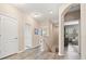 Well-lit hallway with hardwood floors, white doors, and open access to other rooms at 1436 30Th N Ave, St Petersburg, FL 33704