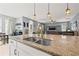 Kitchen island with granite countertop, double sink, and view of the dining area and living room at 1436 30Th N Ave, St Petersburg, FL 33704