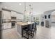 Well-lit kitchen with island seating, stainless appliances, and an adjacent dining area with large windows at 1436 30Th N Ave, St Petersburg, FL 33704