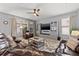 Spacious living room with plush seating, ceiling fan, and ample natural light at 1436 30Th N Ave, St Petersburg, FL 33704