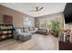 Cozy living room with a gray sectional sofa, a bookshelf, and wood flooring at 1436 30Th N Ave, St Petersburg, FL 33704