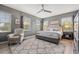 Main bedroom featuring a comfortable bed, multiple windows, and a ceiling fan at 1436 30Th N Ave, St Petersburg, FL 33704