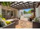 Inviting covered patio with comfortable seating, a fire pit, and lush tropical landscaping and pool at 1436 30Th N Ave, St Petersburg, FL 33704