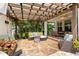 Inviting covered patio with comfortable seating, a fire pit, and lush tropical landscaping at 1436 30Th N Ave, St Petersburg, FL 33704