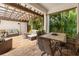Inviting outdoor patio with comfortable seating, a stone fire pit, lush tropical landscaping, and a covered pergola at 1436 30Th N Ave, St Petersburg, FL 33704