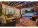A covered patio features an outdoor dining area, seating, fire pit, and string lights, perfect for relaxation at 1436 30Th N Ave, St Petersburg, FL 33704