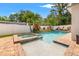 Backyard pool and patio offering a refreshing oasis with lush landscaping and privacy fence at 1436 30Th N Ave, St Petersburg, FL 33704