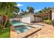 Backyard pool and patio offering a refreshing oasis with lush landscaping and privacy fence at 1436 30Th N Ave, St Petersburg, FL 33704