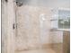 Modern walk-in shower with beige tile, glass enclosure, and contemporary fixtures at 1436 30Th N Ave, St Petersburg, FL 33704