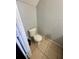 Standard toilet with neutral wall and floor tiles at 144 Douglas W Rd # F, Oldsmar, FL 34677