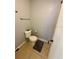 Bathroom with a standard toilet, tiled floor, and towel rack at 144 Douglas W Rd # F, Oldsmar, FL 34677
