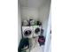 Compact laundry room with side by side washer and dryer units at 144 Douglas W Rd # F, Oldsmar, FL 34677