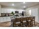 Modern kitchen with white cabinets, stainless steel appliances, and a large center island at 14807 Summer Branch Dr, Lithia, FL 33547