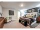This is a spacious main bedroom that includes a stylish bed, an accent wall, and an adjacent sitting area at 14807 Summer Branch Dr, Lithia, FL 33547