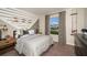 Stylish bedroom with neutral decor, fish-themed accents, and ample natural light at 14815 Summer Branch Dr, Lithia, FL 33547