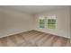 Comfortable bedroom with plush carpet, neutral paint, and two bright windows at 14815 Summer Branch Dr, Lithia, FL 33547