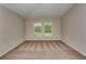 Neutral bedroom with plush carpet, neutral paint, and two bright windows at 14815 Summer Branch Dr, Lithia, FL 33547